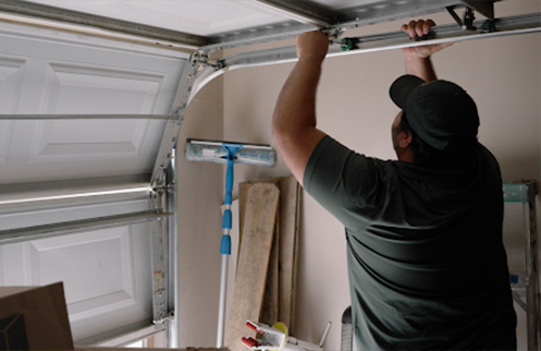 Technician Repairing Garage Door